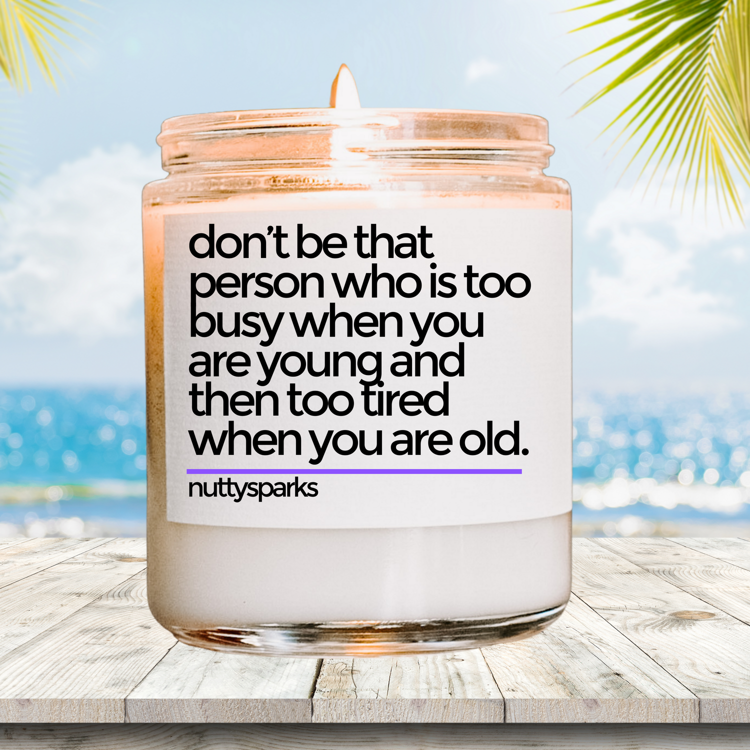 a candle with a quote on it sitting on a table