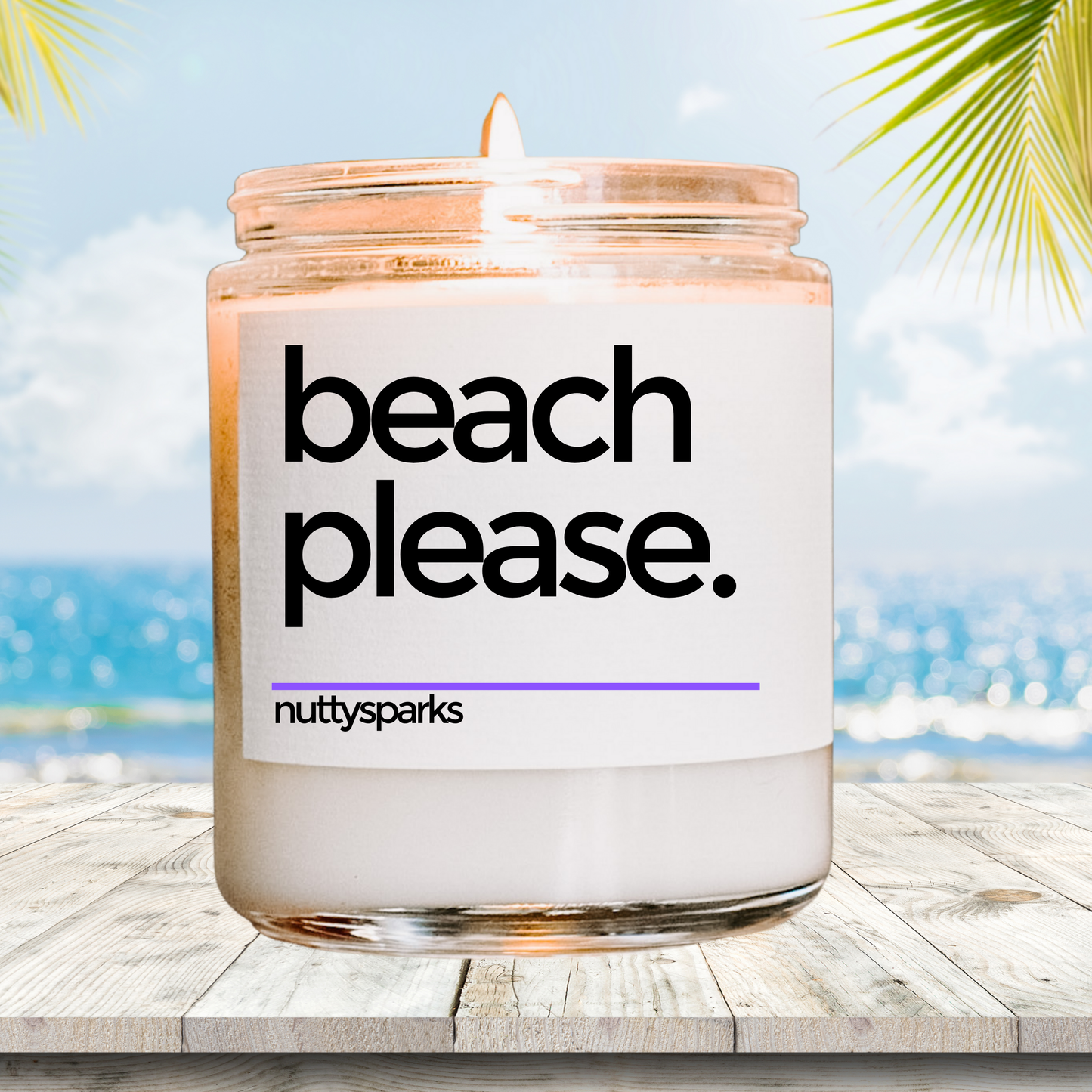 a beach please candle sitting on a wooden table