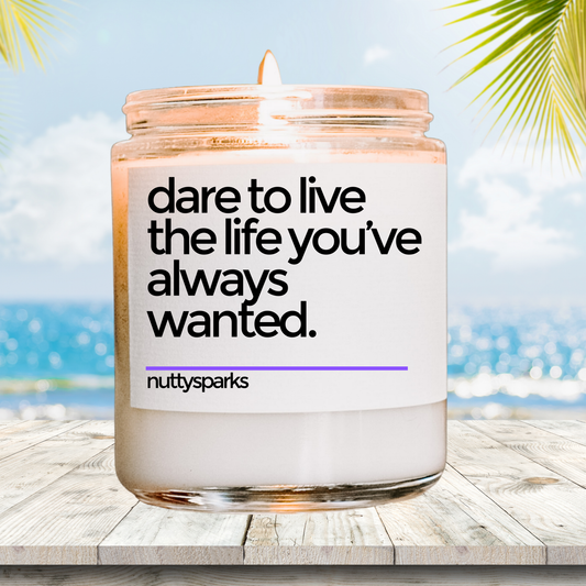 a candle with a quote on it sitting on a table