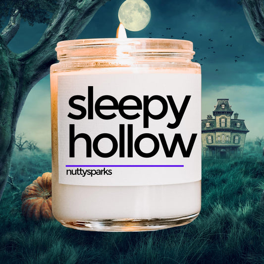 a candle with a creepy house in the background