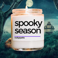 a jar of spooky season candle sitting in front of a spooky