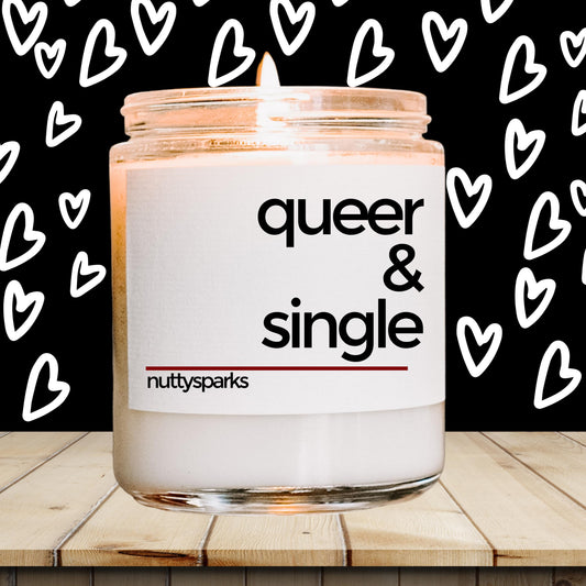 a candle with the words queen and single on it