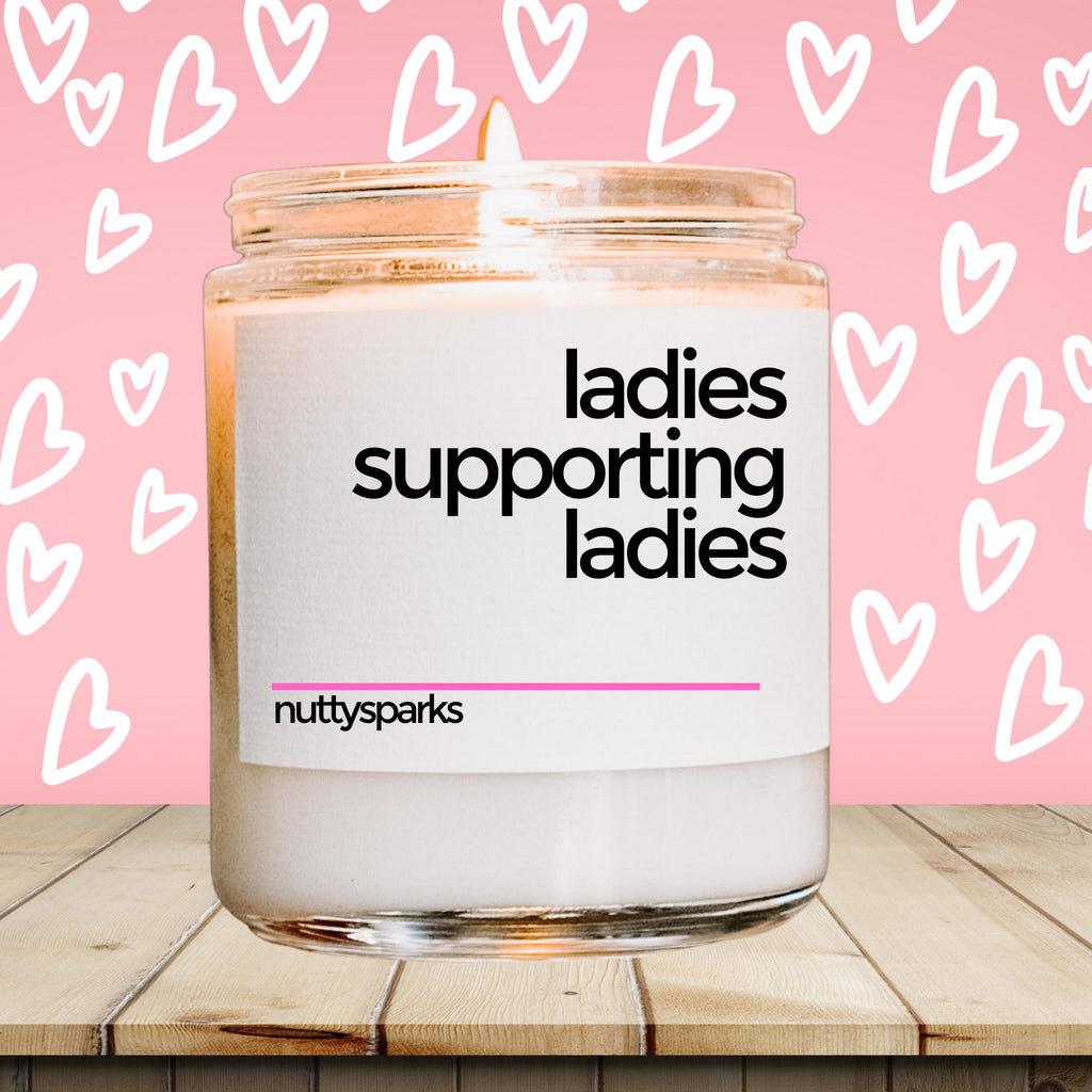 a jar of ladies supporting ladies on a wooden table