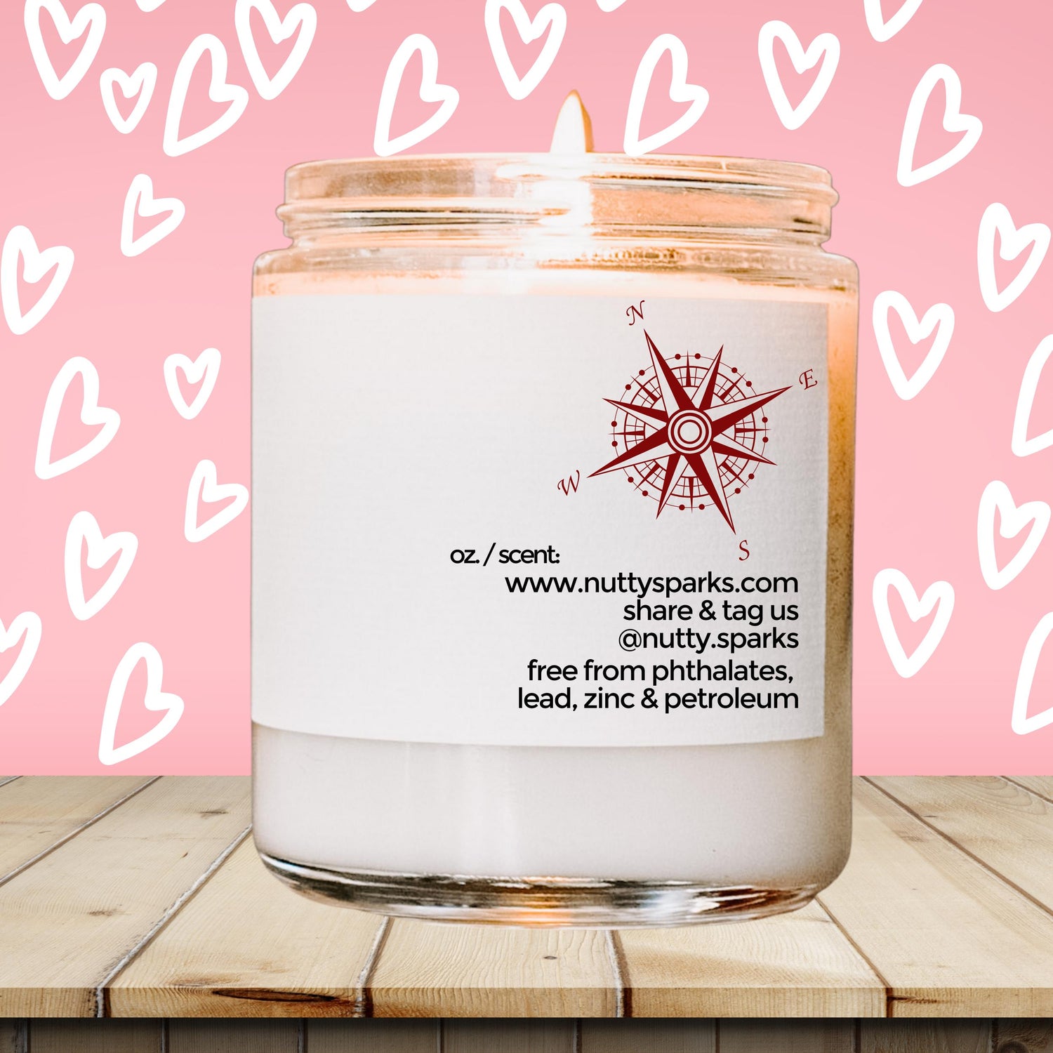 a white candle with a pink background with hearts