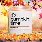 it&#39;s pumpkin time candle surrounded by fall leaves