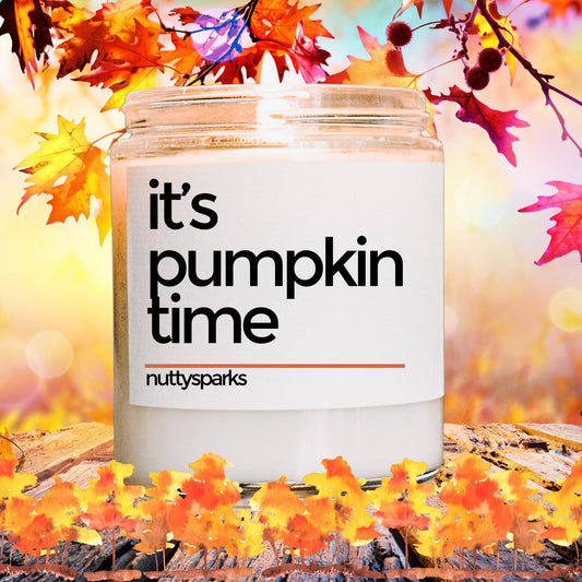 it's pumpkin time candle surrounded by fall leaves