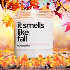 a jar of it smells like fall surrounded by fall leaves