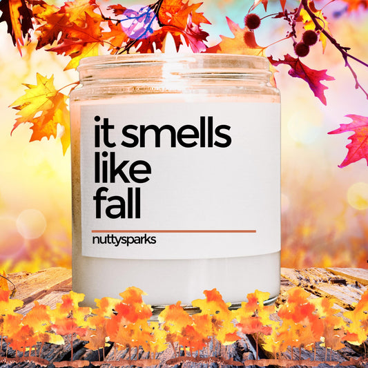 a jar of it smells like fall surrounded by fall leaves