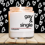 a jar of gay and single candles sitting on a table