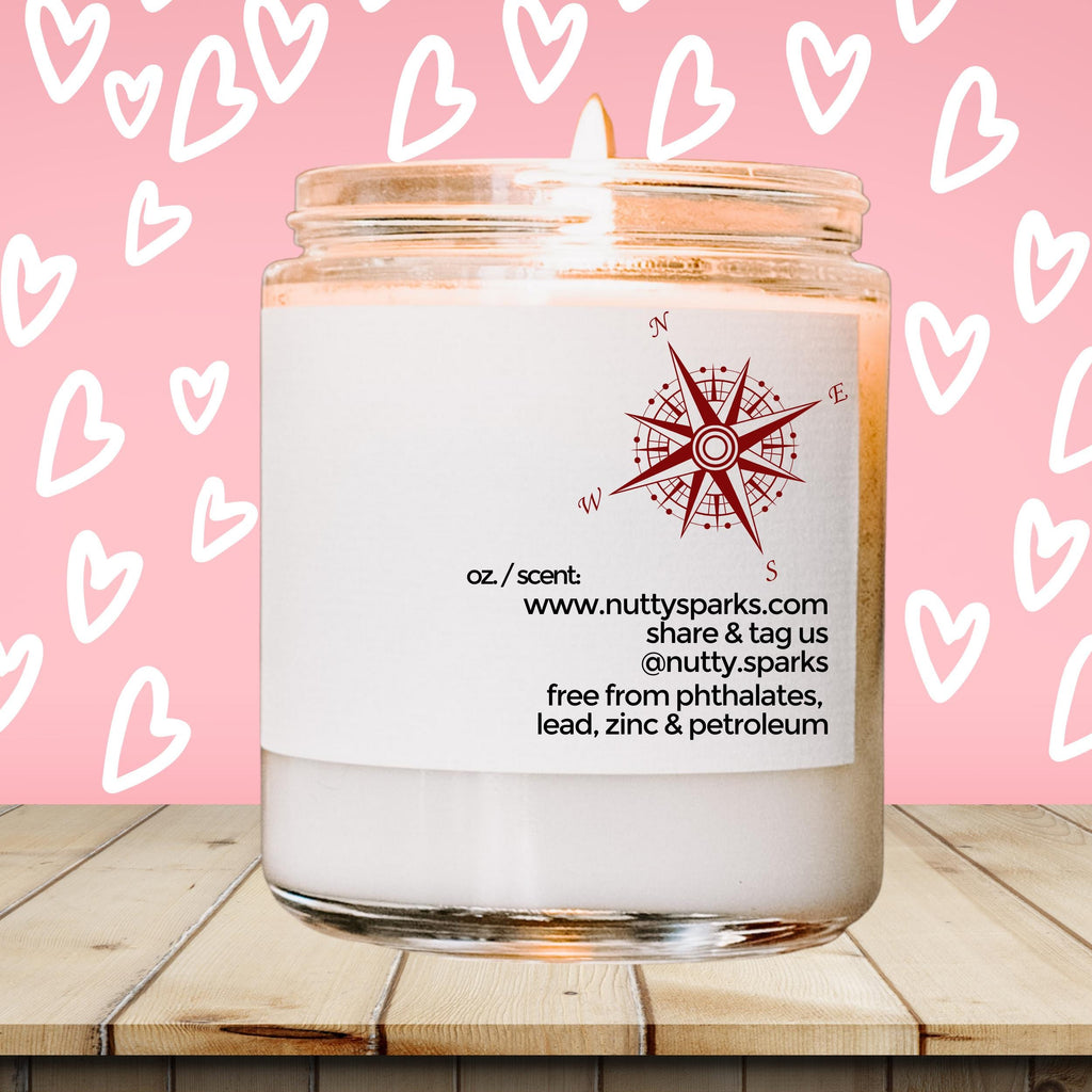 a white candle with a pink background with hearts